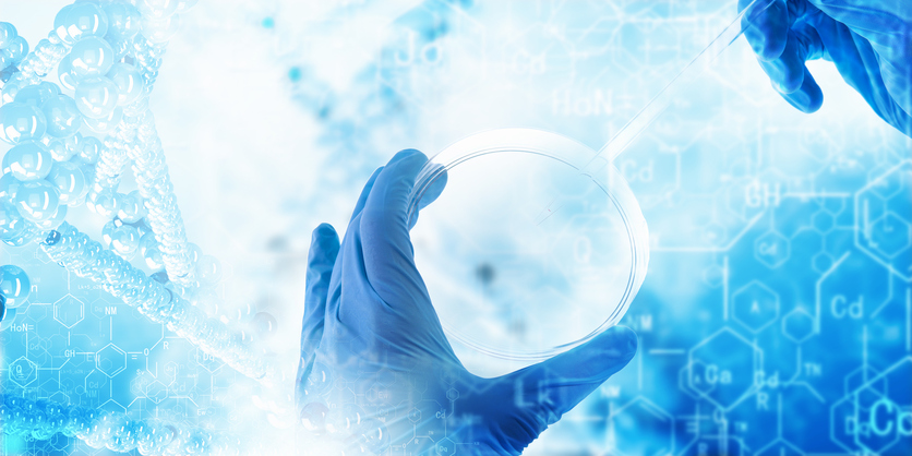 Gloved hands holding dish with abstract chemistry background